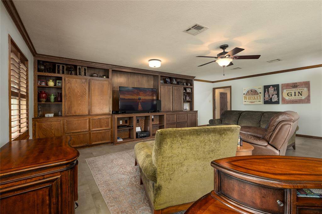 Family Room has carpet flooring and a recent ceiling fans.