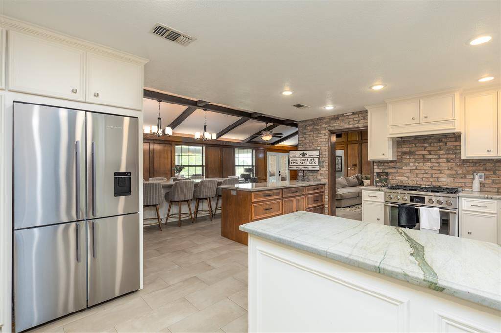 Kitchen has be redone, with a Large Stainless  Steel side by side refrigerator. Kitchen appliances are all Fisher & Paykel Appliances.
