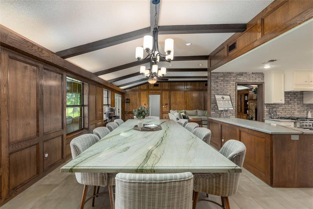 Large Dinning room with a built in table with 10 chairs.