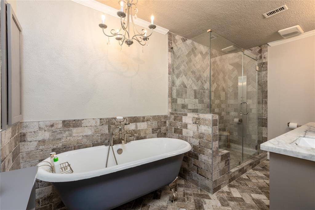 Main Bathroom has been updated with Claw foot bathtub and tile flooring.  Walk in tile shower with a shower seat.