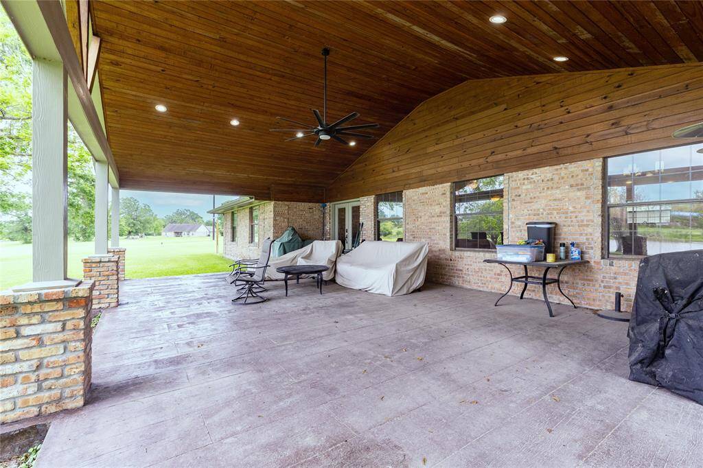 Large Covered porch with ceiling fans and pocket lighting.