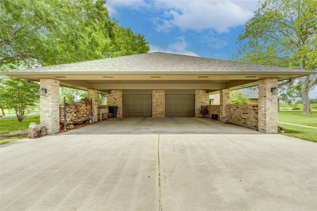 Large Porte Cochere has room for two cars along with an area used for storage.