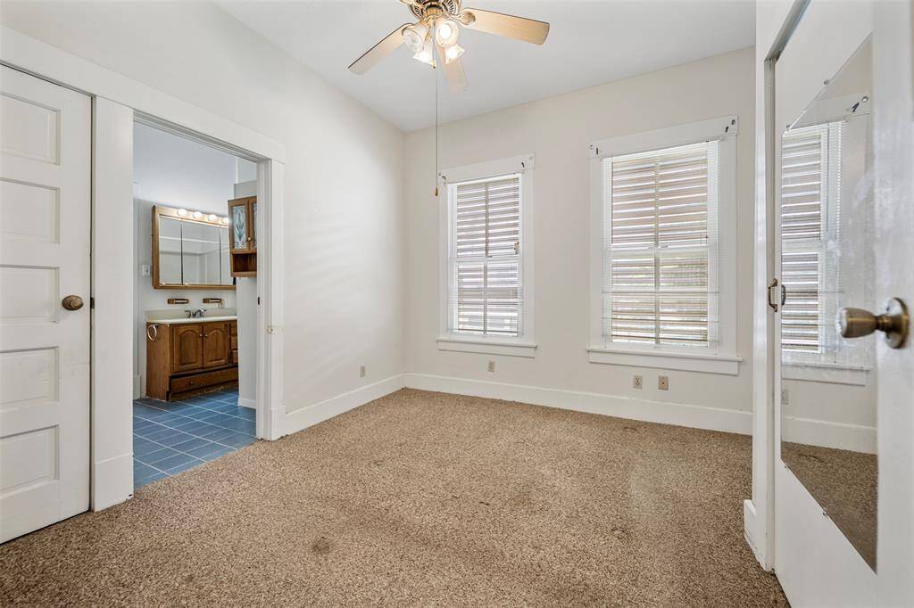 Primary bedroom with entrance to the primary bathroom.