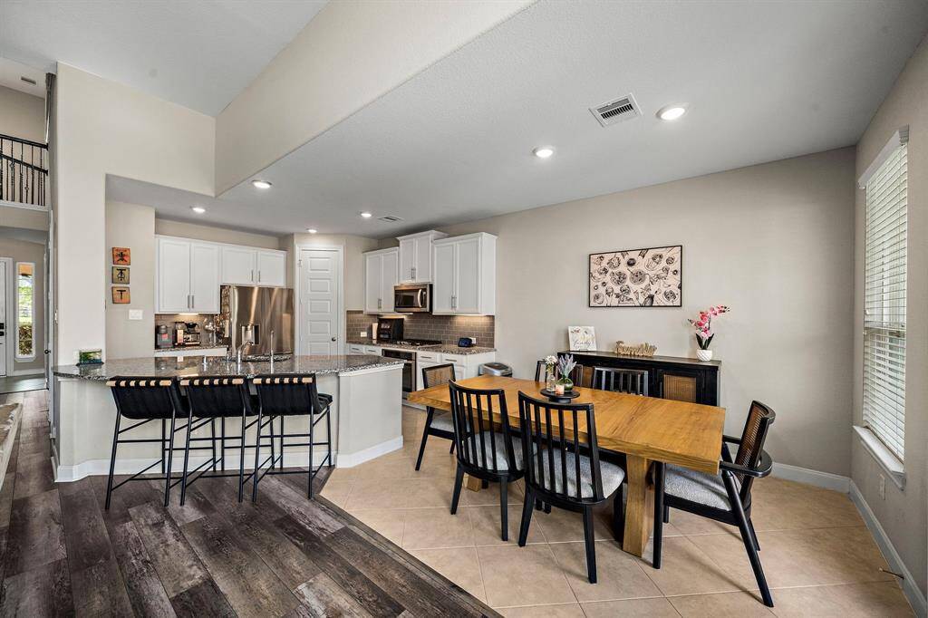With its seamless flow from the kitchen to the dining space, this open-concept design makes hosting effortless. Bright windows and neutral tones enhance the airy, welcoming feel throughout the main living spaces.