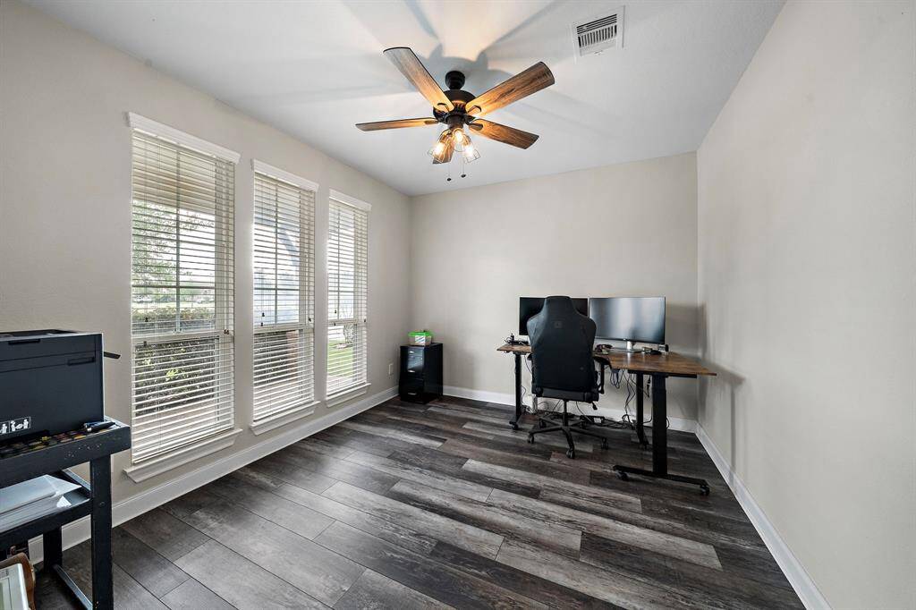 The flexible downstairs office offers a quiet retreat with abundant natural light streaming through triple windows. Whether used as a dedicated workspace, study, or bonus room, it delivers comfort and functionality to suit your needs.