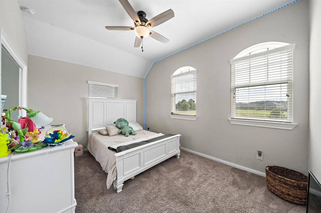 A second upstairs bedroom offers stunning views and double windows that flood the room with natural light. Elevated ceilings and thoughtful design details create an airy, open feel.