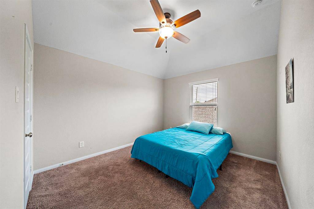 Another generously sized bedroom provides flexibility for guests, a home office, or a personal retreat. Fresh neutral paint and soft carpeting ensure a peaceful, comfortable space.