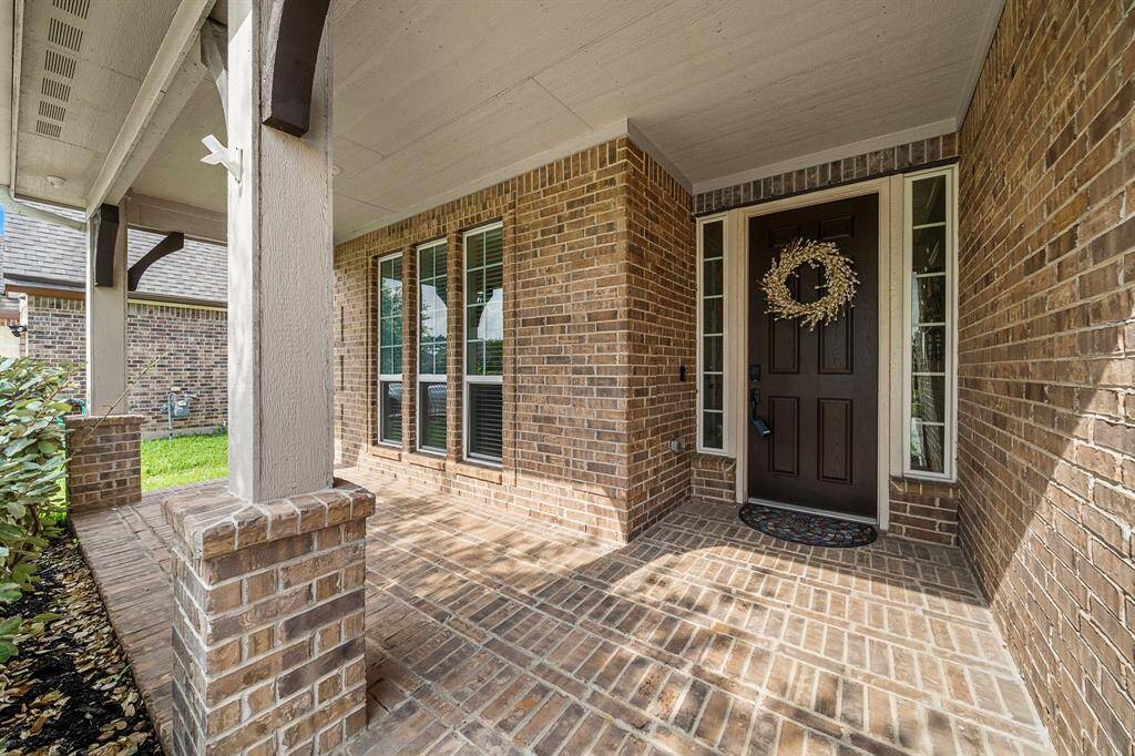 A charming covered front porch welcomes you home with space to sit and enjoy the quiet, established neighborhood. Brick accents, tall windows, and a classic front door with sidelights set the tone for the stylish, thoughtfully maintained interior beyond.