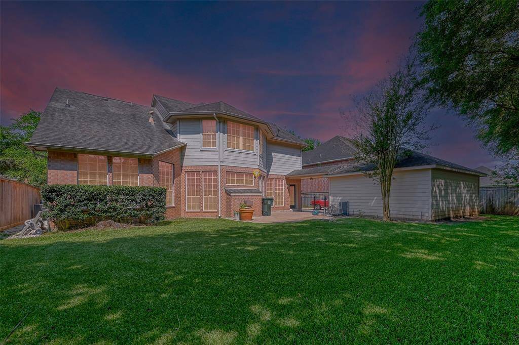 THE BACK OF THE HOME WITH PLENTY OF SPACE FOR KIDDOS AND PETS TO ROAM.
