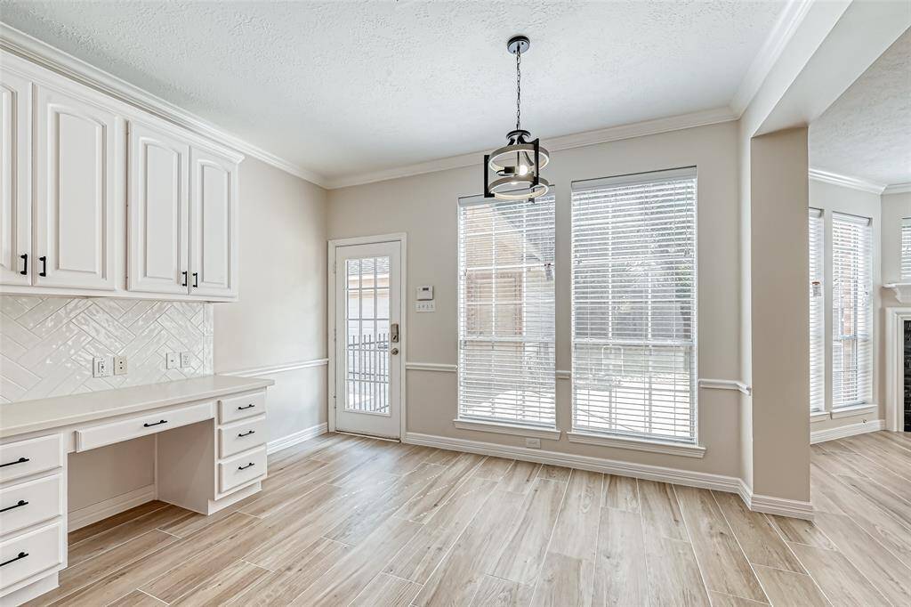 UPGRADED LIGHTING GRACES THE BREAKFAST ROOM.