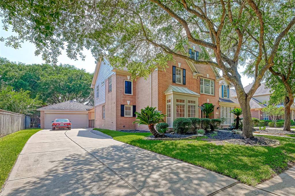 THIS STATELY HOME OFFERS A WIDE DRIVEWAY WITH 2-CAR DETACHED GARAGE.