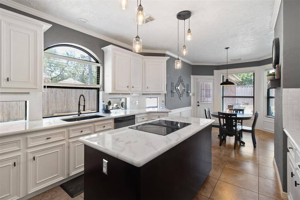 Bright and inviting kitchen with elegant counters and cabinets, perfect for cooking and entertaining.