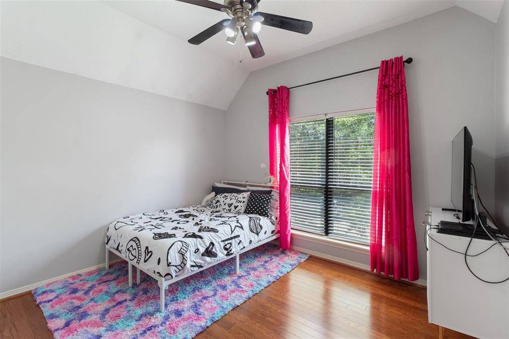 Front-facing secondary bedroom, offering ample natural light and cozy comfort.