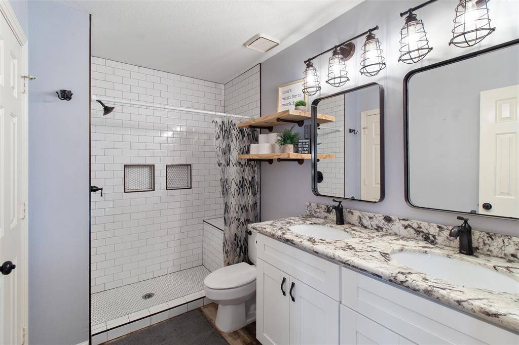 Upstairs, enjoy a fully renovated bathroom with double sinks and modern charm.