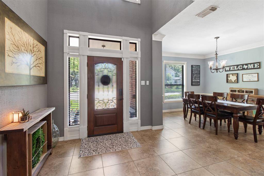 This large dining room at the front of the home offers abundant natural light and convenient kitchen access.