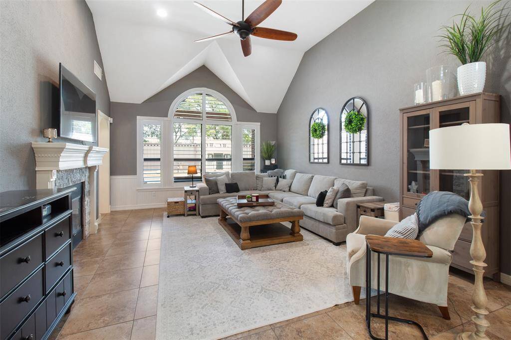 Comfort and modern charm can be found in this large living room outfitted with plantation shutters.