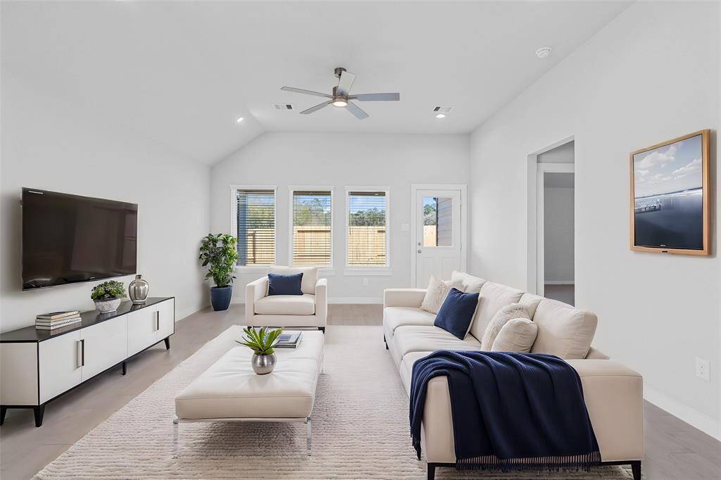 Gather the family and guests together in your lovely family room! Featuring soaring high ceilings, recessed lighting, ceiling fan, custom paint, gorgeous floors and large windows that provide plenty of natural lighting throughout the day.