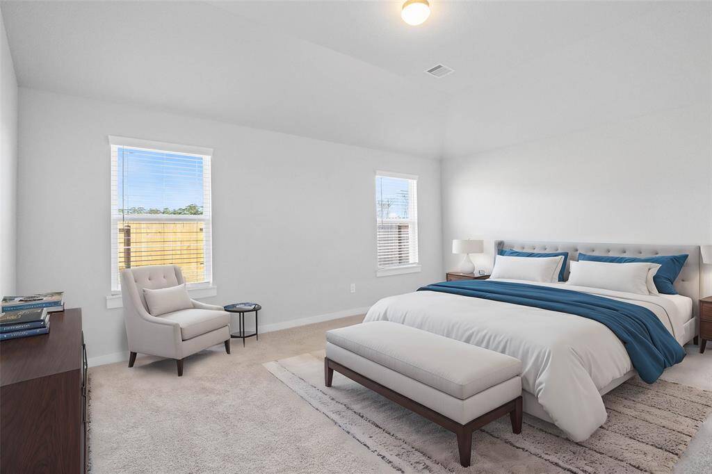 Come and unwind after a long day in this magnificent primary suite! This spacious room features plush carpet, warm paint, high ceilings and large windows with privacy blinds.