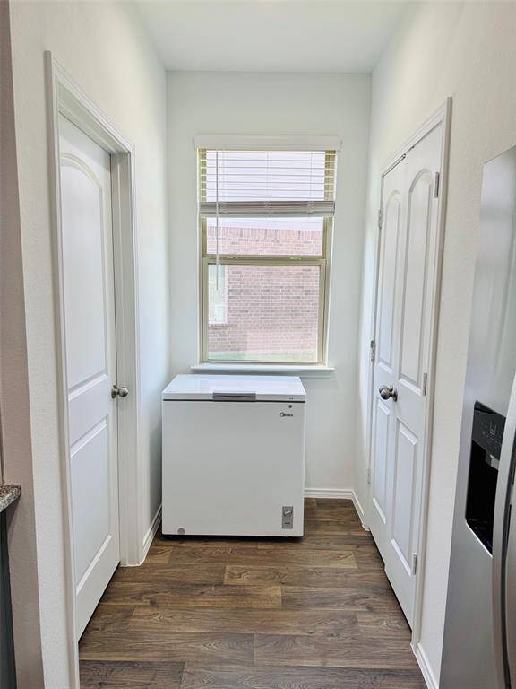 Hallway to the utility room with window creates more light coming through the house.