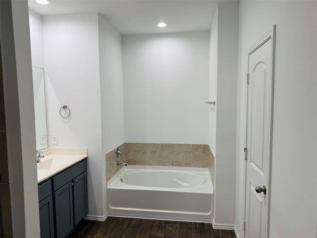 Step into the primary bathroom and enjoy the standing shower, soaking tub.