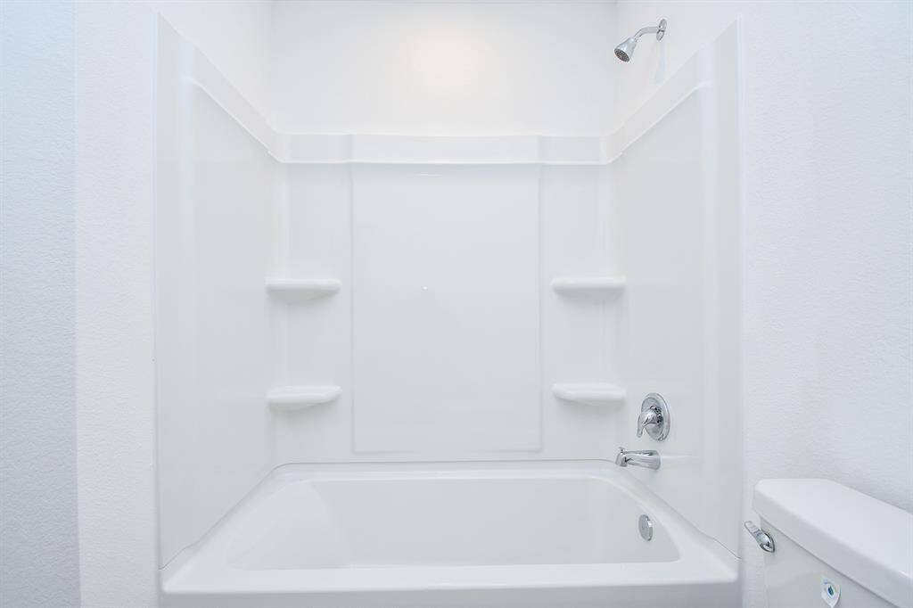 Guest bathroom is complete witha shower/tub combo.