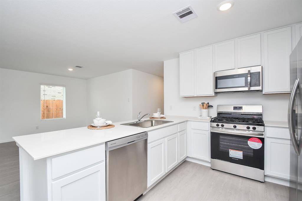Modern white cabinets with allyour stainless steel appliances.