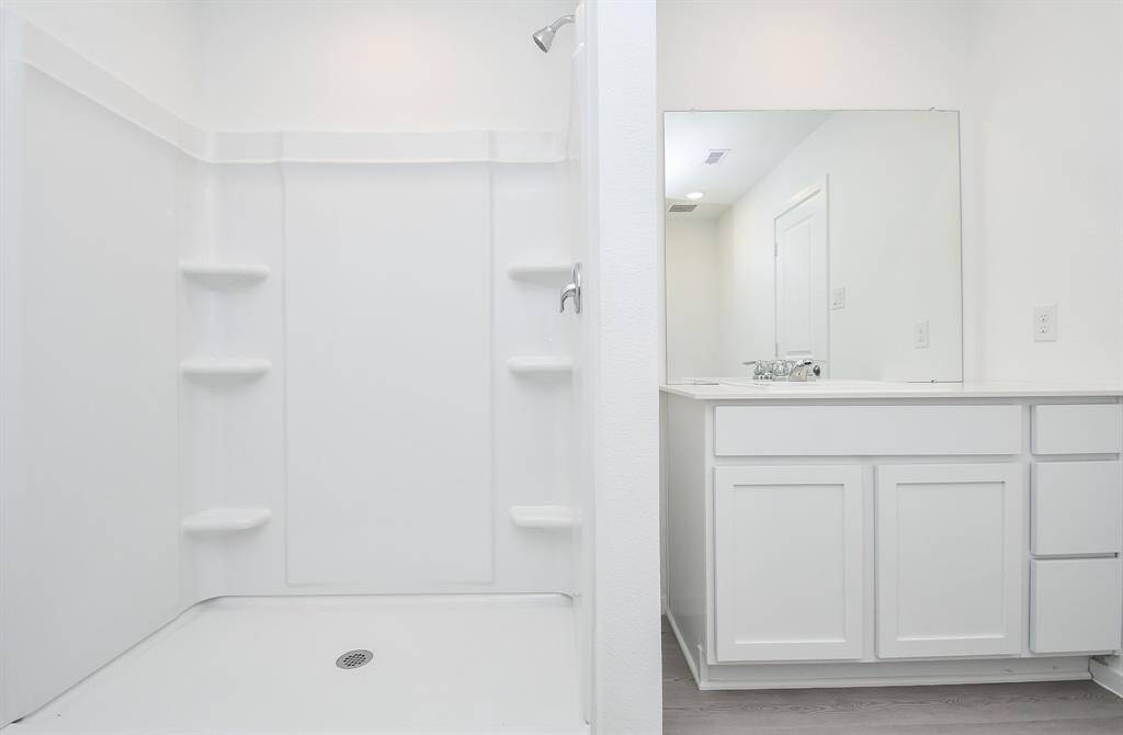 Indulge in a hot shower daily inyour stand up shower with builtin shelves.