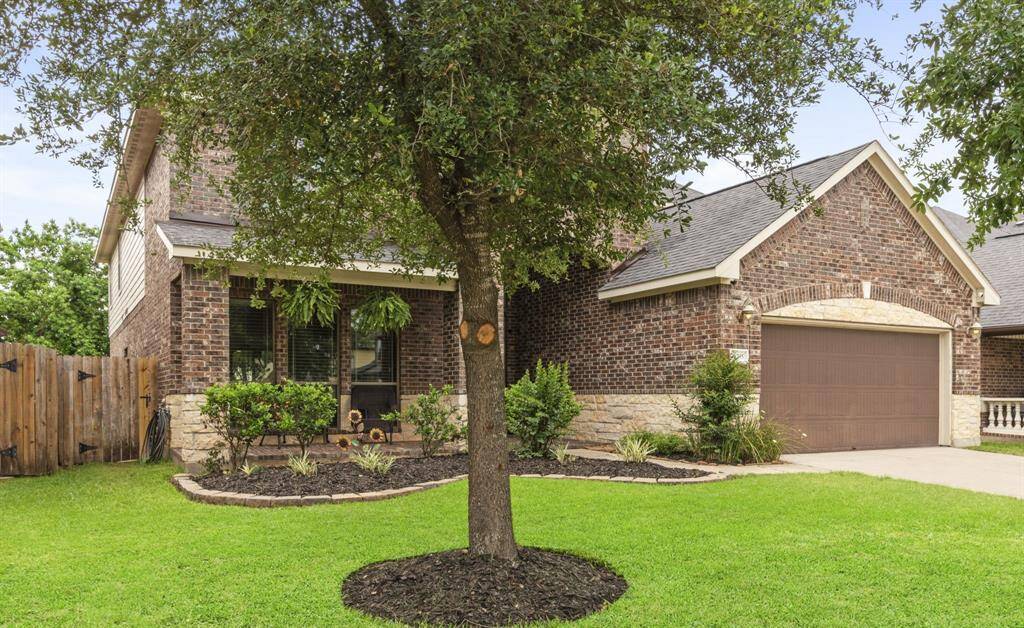 This inviting living room features a high ceiling and a cozy stone fireplace! Perfect for comfortable family living.