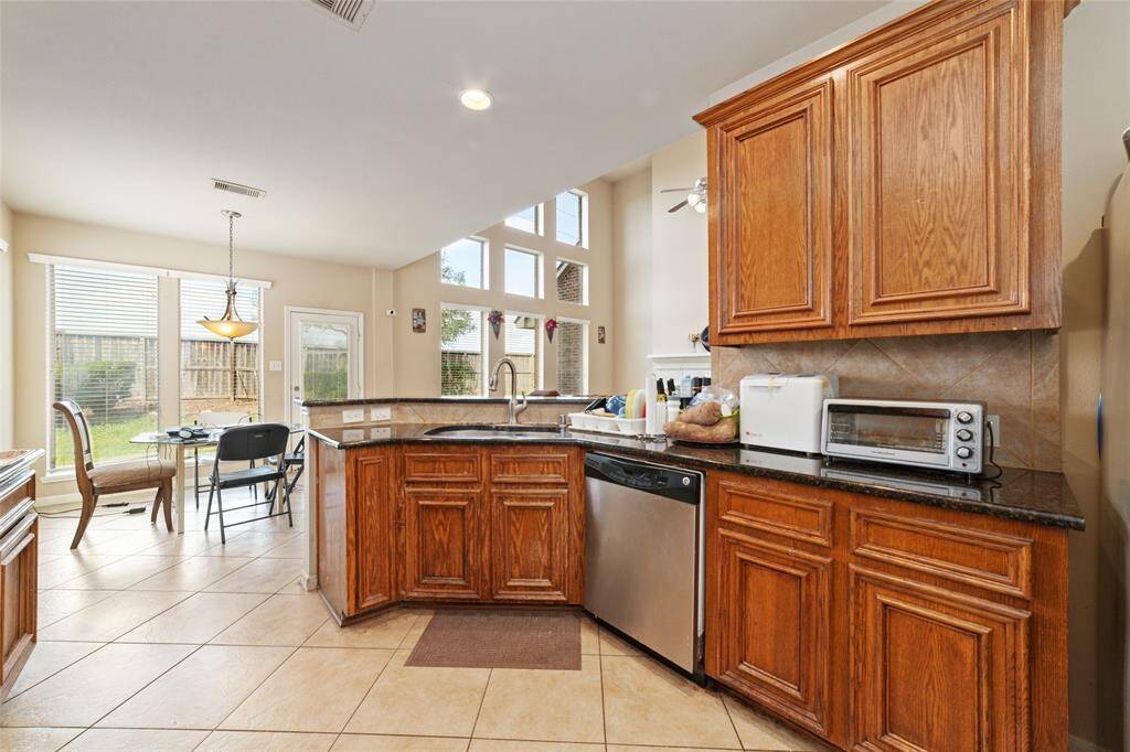 Family room and kitchen have so many windows to catch natural sunlight.