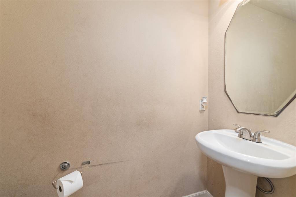 A convenient powder room located in the garage entrance to the house.
