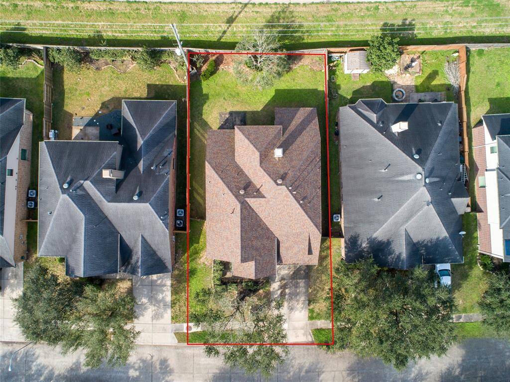 The aerial view of the house with look liked brand new roof.