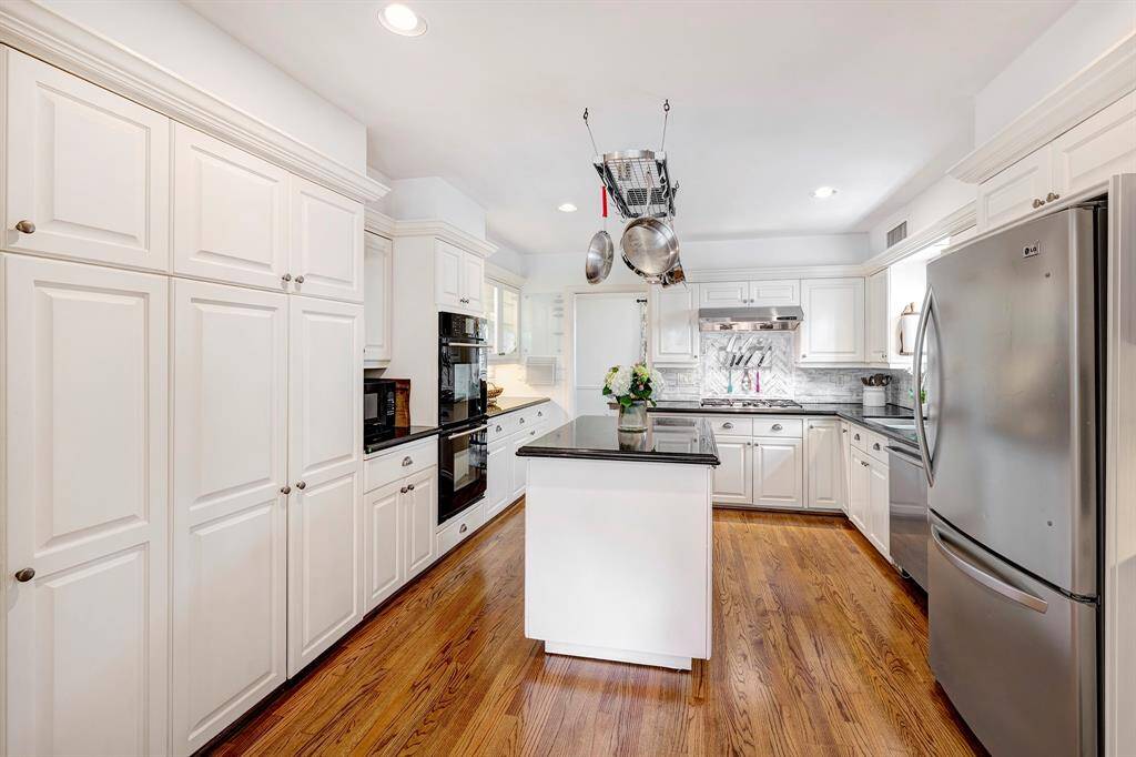 Along the east wall, there are tall cabinet doors for pantry storage, cookware and additional kitchen gadgets. Don't miss the classic swinging door to the dining room.