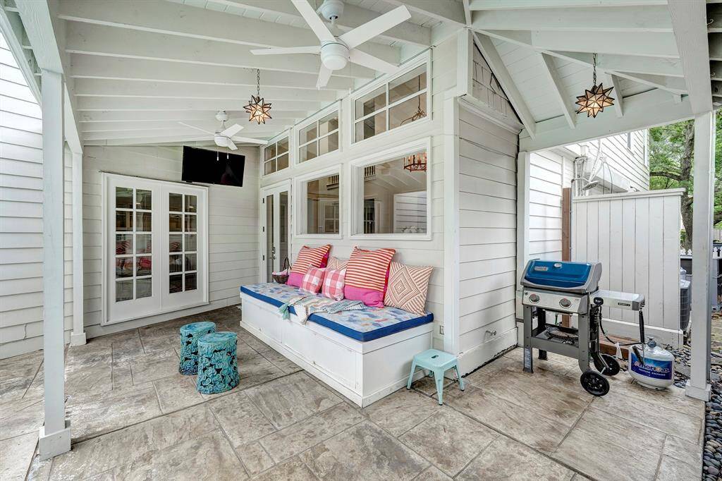 The covered veranda [15' x 9'] backs up the breakfast room and is a delightful spot for relaxing, watching TV and catching all the action in the pool! The two-car detached garage is pictured in the background. There is a pool bath behind the right side door.