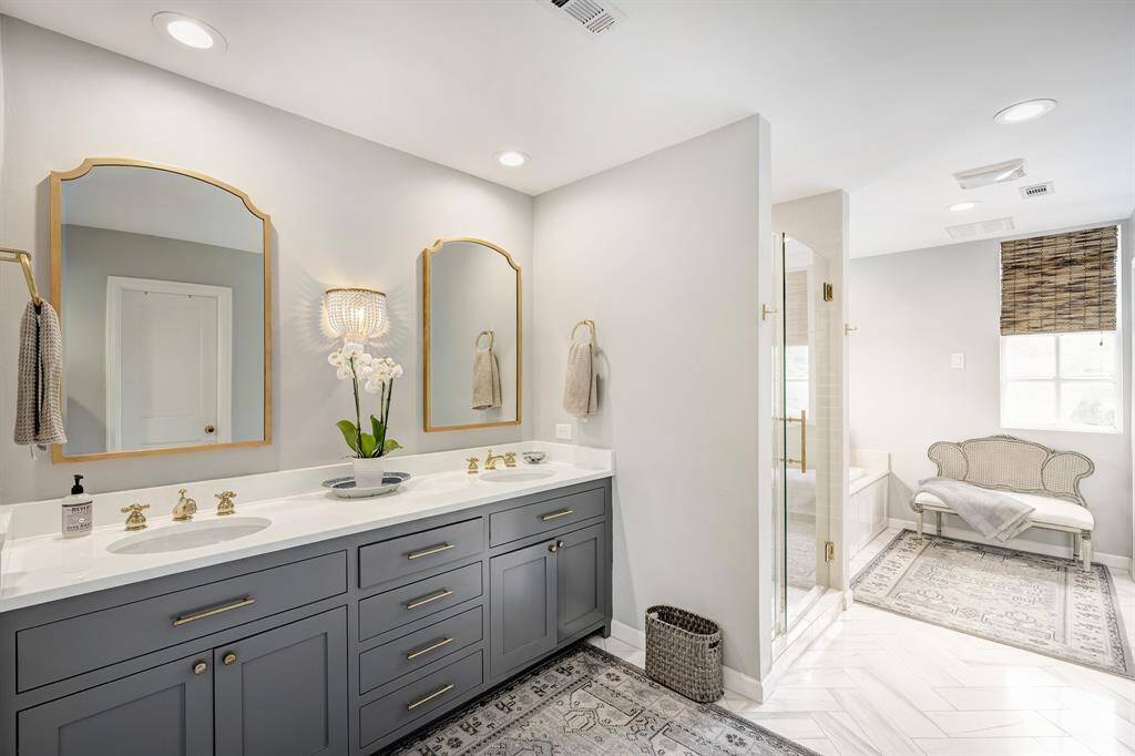 This primary corridor connects the primary bedroom to the renovated en-suite bathroom. This view provides a glimpse of the soaring ceilings of the breakfast room.