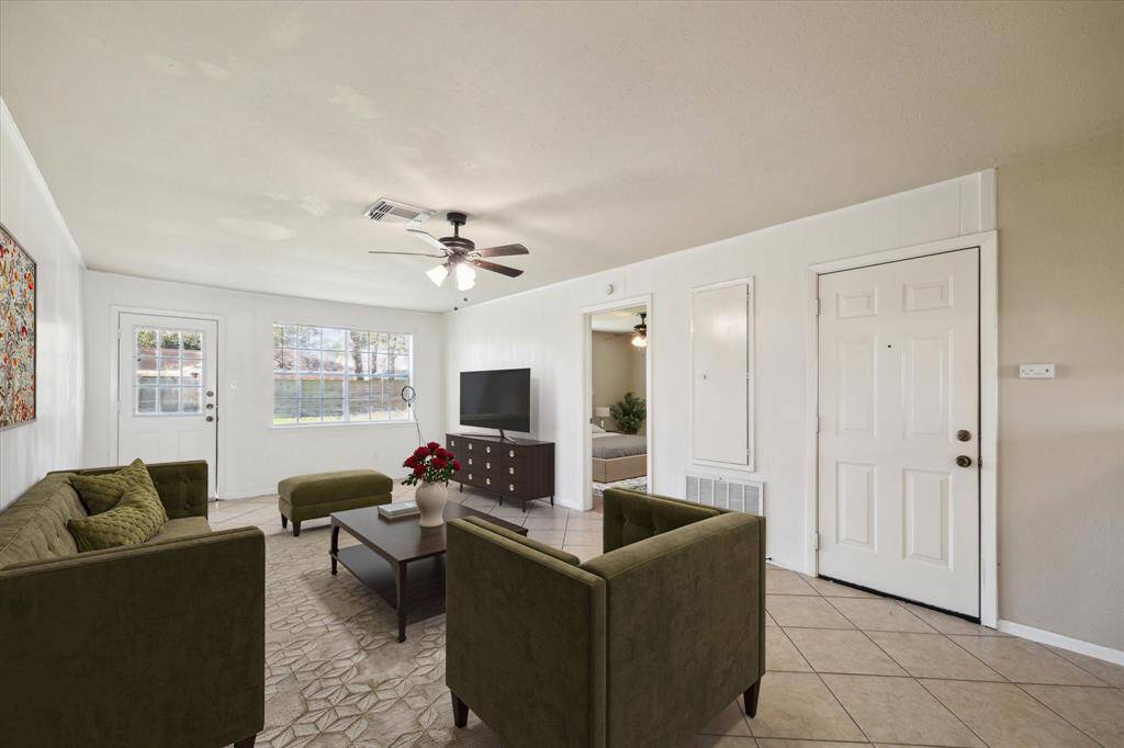 Main living area with access to backyard. *Virtually Staged
