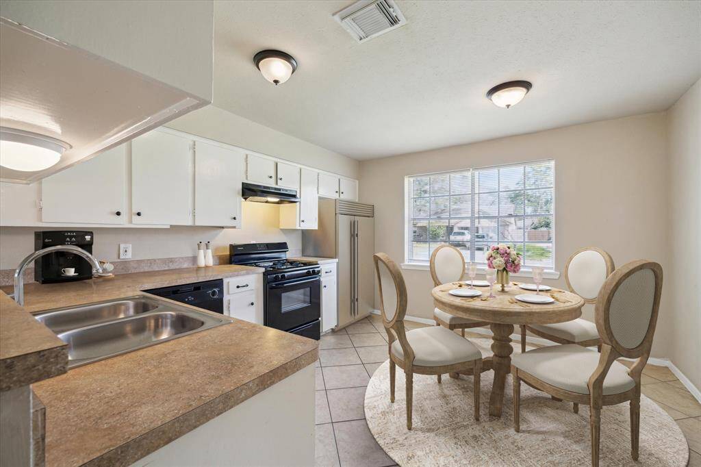 Kitchen with open breakfast area. *Virtually Staged