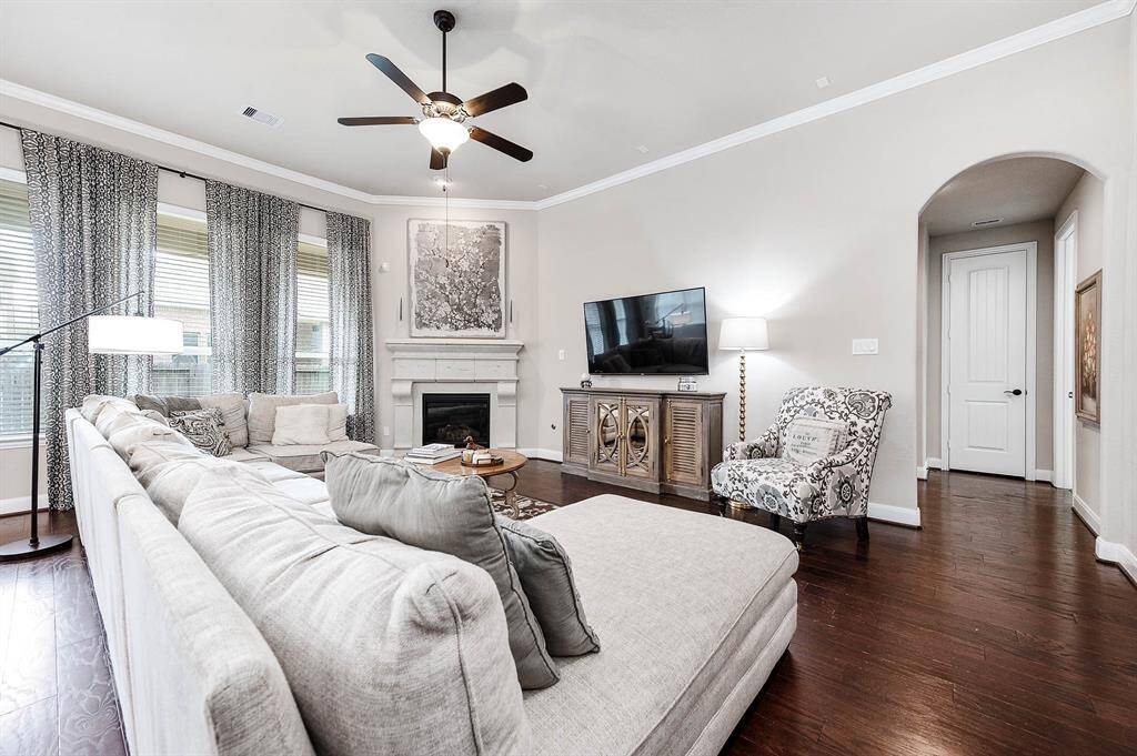 The large sectional shows just how spacious this living room is with access to the bedrooms to the right.