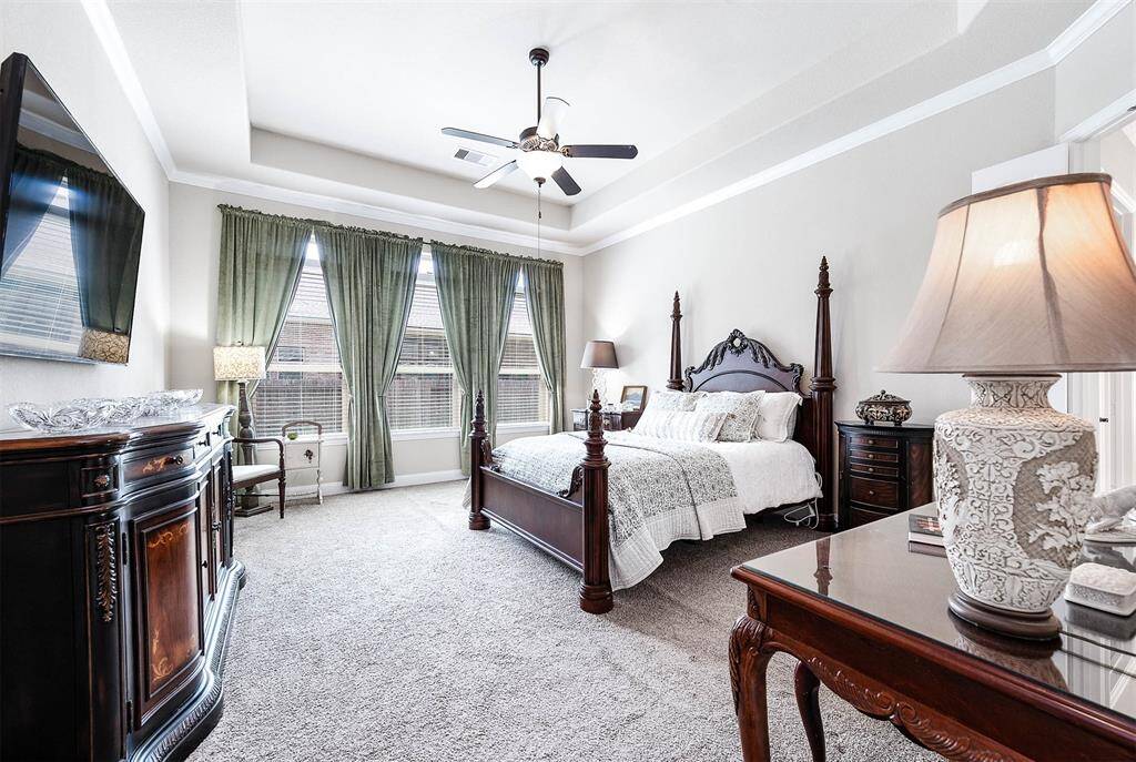 The primary bedroom showcases lots of natural light, spacious room, and vaulted ceiling.