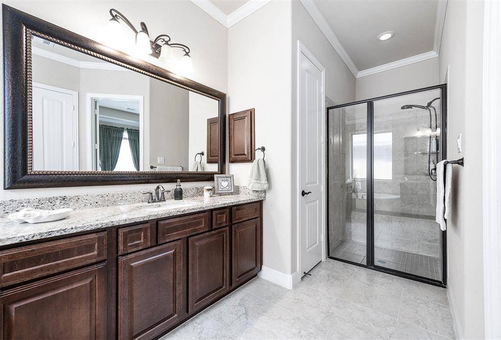 The primary bathroom also features a walk in shower with bench.