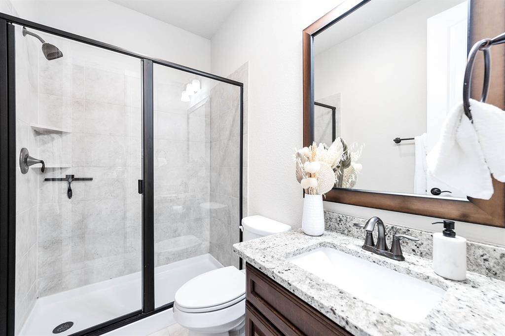 Secondary bathroom with standing shower.