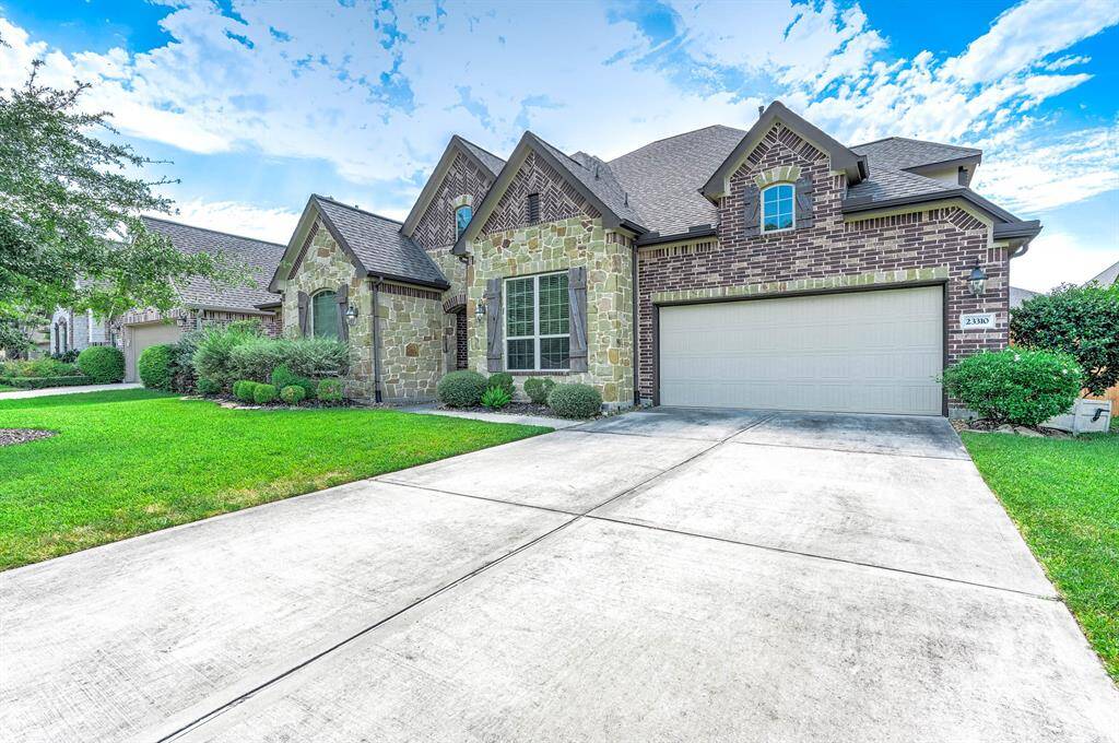 Expansive driveway with 3 car tandem garage.