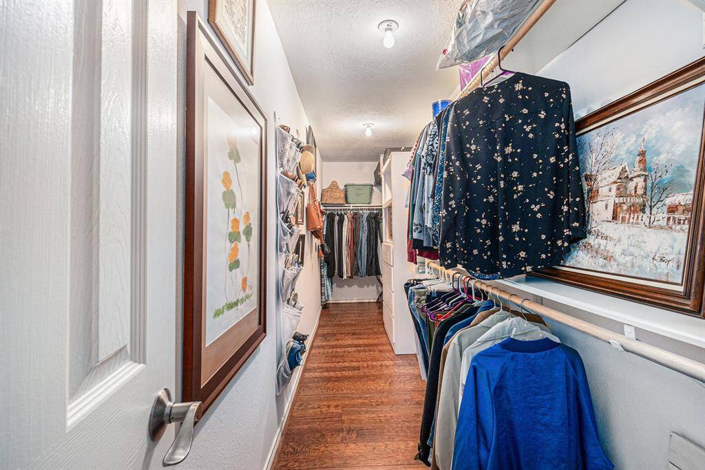 View of the primary closet with ample storage space.