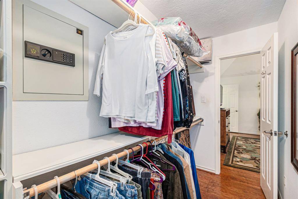 This primary closet also has a built-in safe.