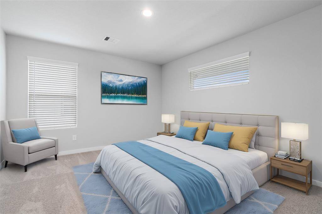 This secondary bedroom features high ceilings, recessed lighting, custom paint, plush carpet, and large windows with privacy blinds!