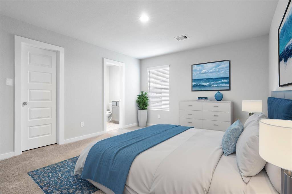 This secondary bedroom features high ceilings, recessed lighting, custom paint, plush carpet, large window with privacy blinds, and its own private bathroom!