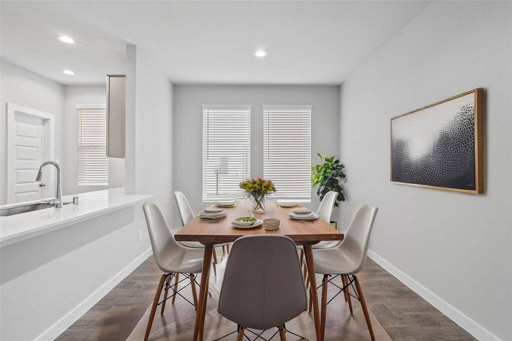 Start your day off right with a cup of coffee sitting with your family in the lovely dining area! Featuring large windows with blinds, custom neutral paint, wood look tile flooring, recessed lighting and high ceilings!