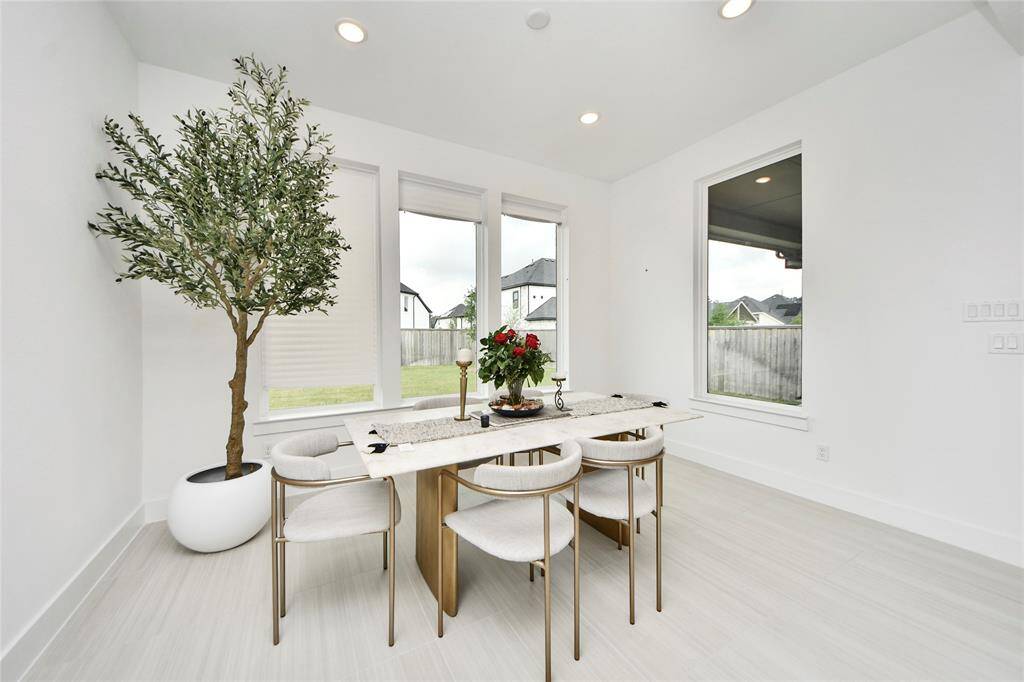 Chic dining nook filled with natural light and serene backyard views—perfect for intimate meals or casual gatherings.