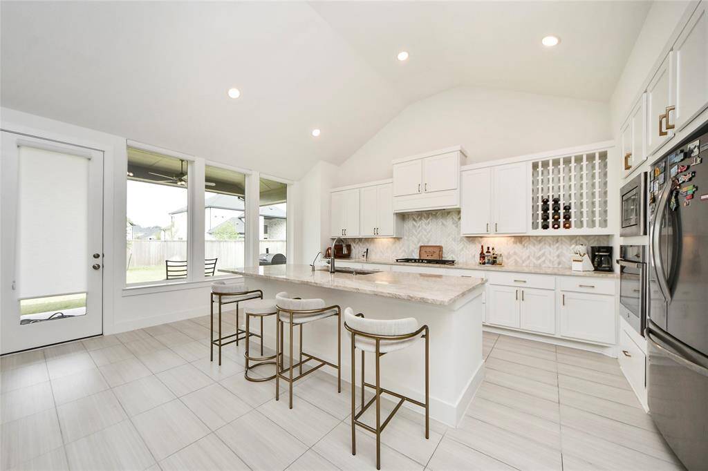 Expansive island for prep and casual dining, plus custom built-in wine storage for added luxury.