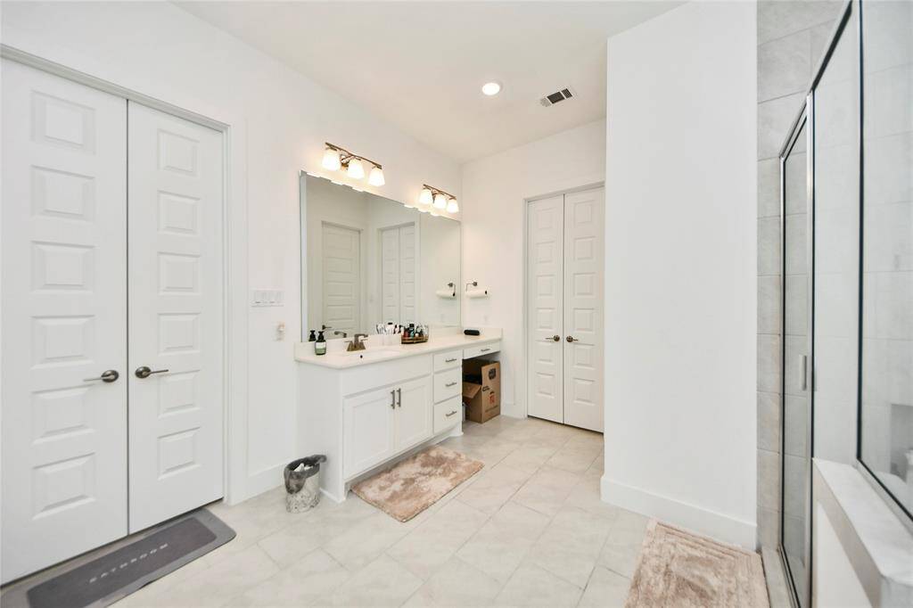 Generously sized primary bath includes a dedicated makeup vanity area and extra linen closet storage.