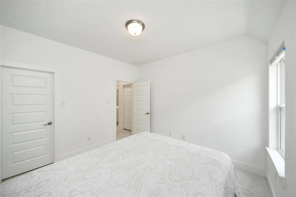 Another look at the third bedroom, showcasing the doorway leading to the hall bath and a second door for closet access.